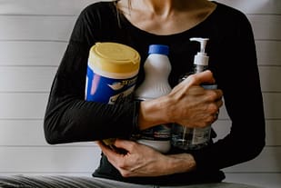 Woman with cleaning products